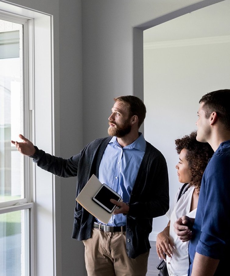 A home and property inspector assessing a home in south florida as he speaks to the homeowners.